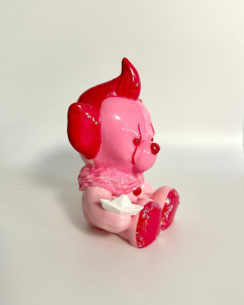 Pink and red figurine on a white background