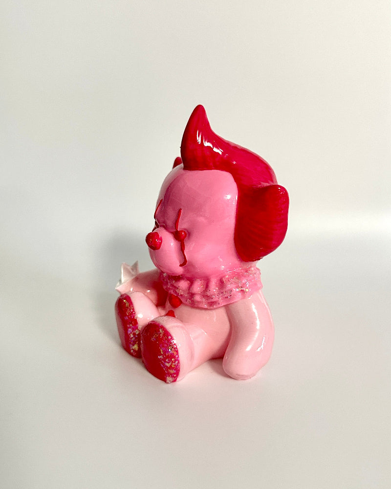 Pink and red figurine on a white background