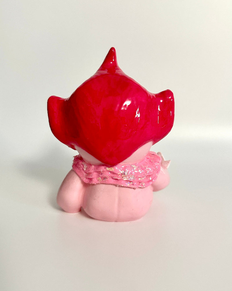 Pink and red figurine on a white background