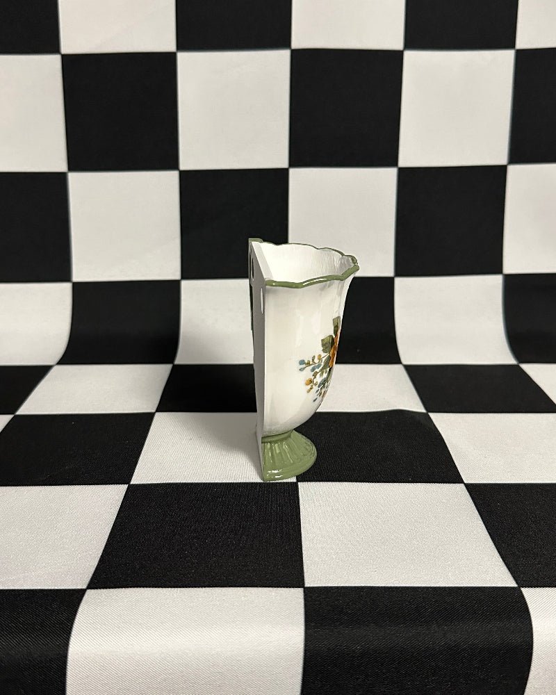 teacup magnet on a black and white checkered background