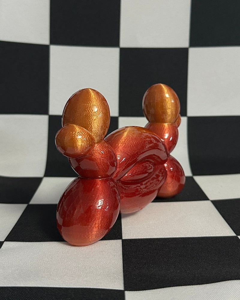 Balloon crab sculpture on a checkered black and white background