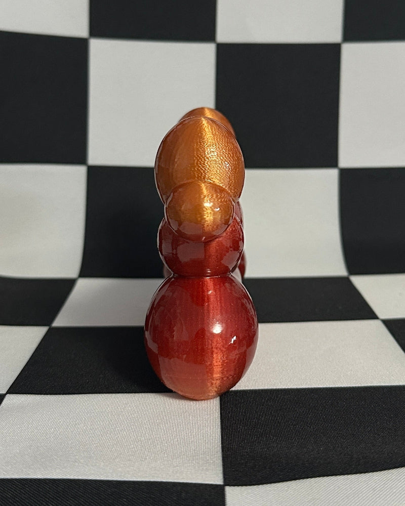 Decorative item resembling a gourd on a checkered black and white background