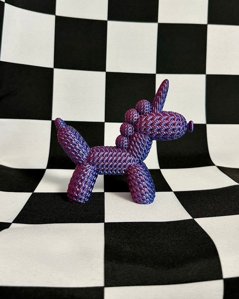 Purple dog-shaped toy on a black and white checkered background