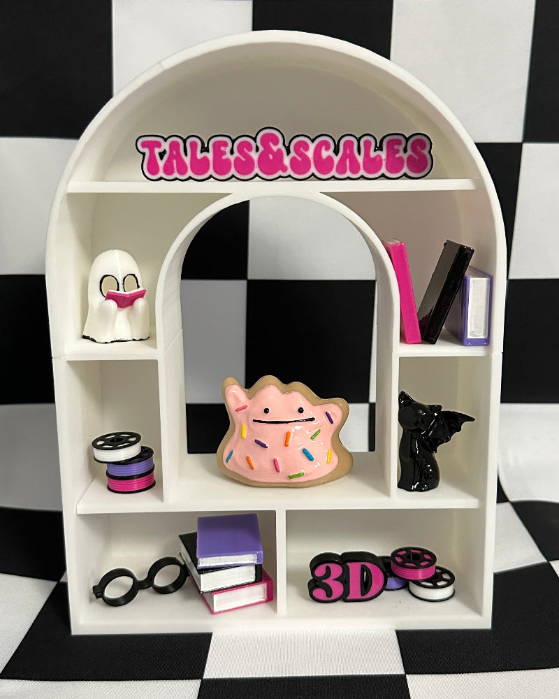 White arch-shaped shelf with decorative items against a black and white checkered background