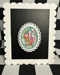 Decorative framed artwork on a black and white checkered background