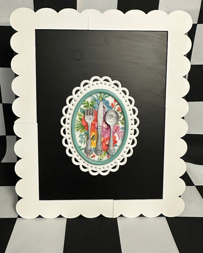 Decorative framed artwork on a black and white checkered background