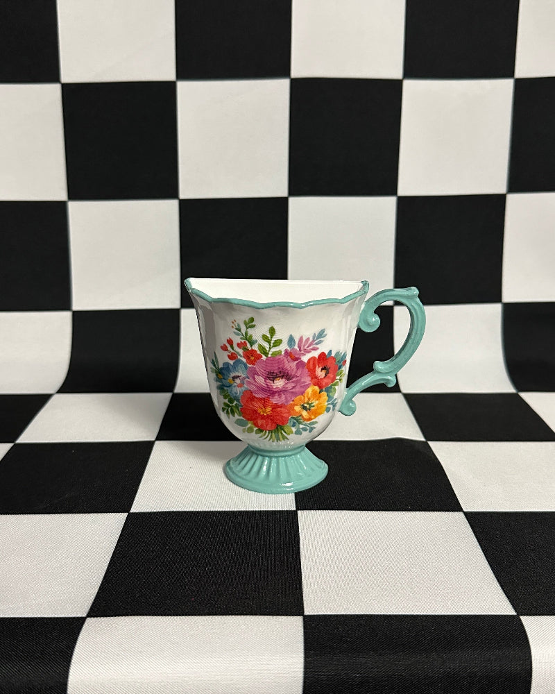 Teacup with floral design on a black and white checkered background