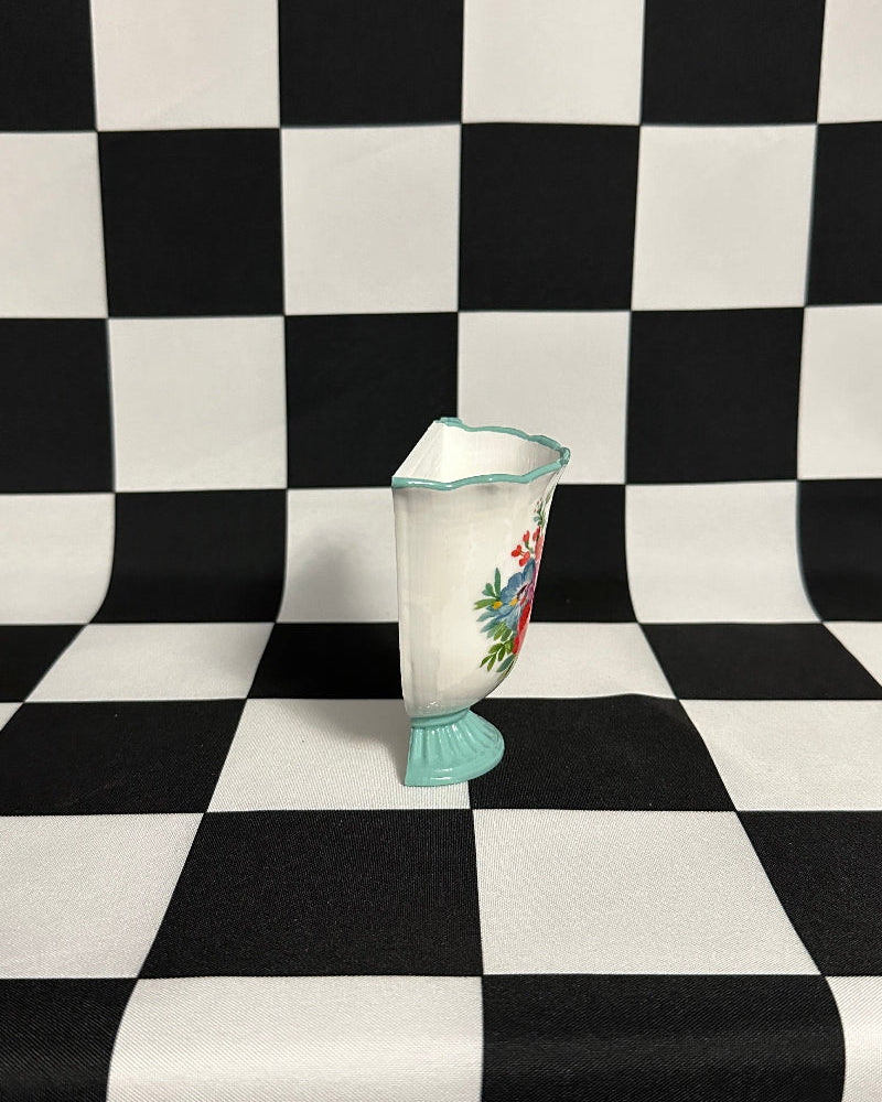 Silver vase on a black and white checkered background