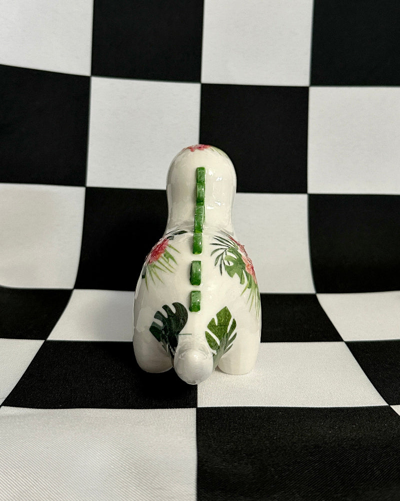 Decorative ceramic duck with leaf pattern on a black and white checkered background