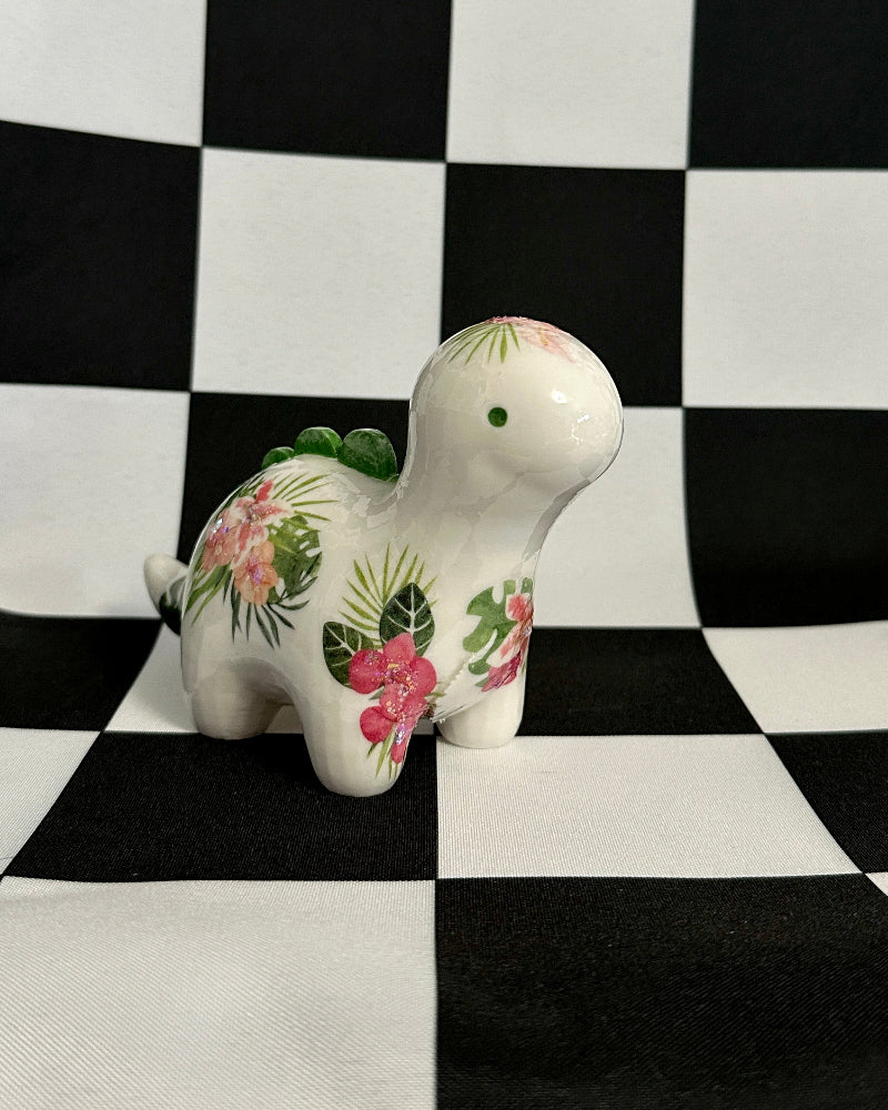 Decorative ceramic turtle figurine with floral patterns on a black and white checkered background