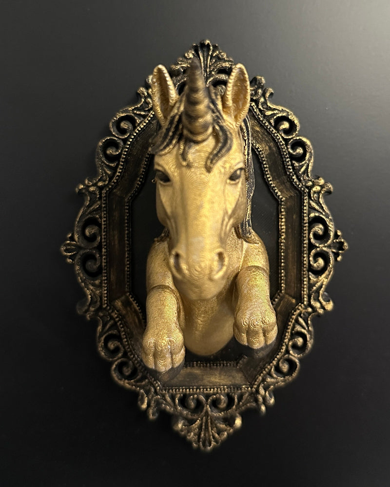 Unicorn figurine in an ornate frame on a dark background