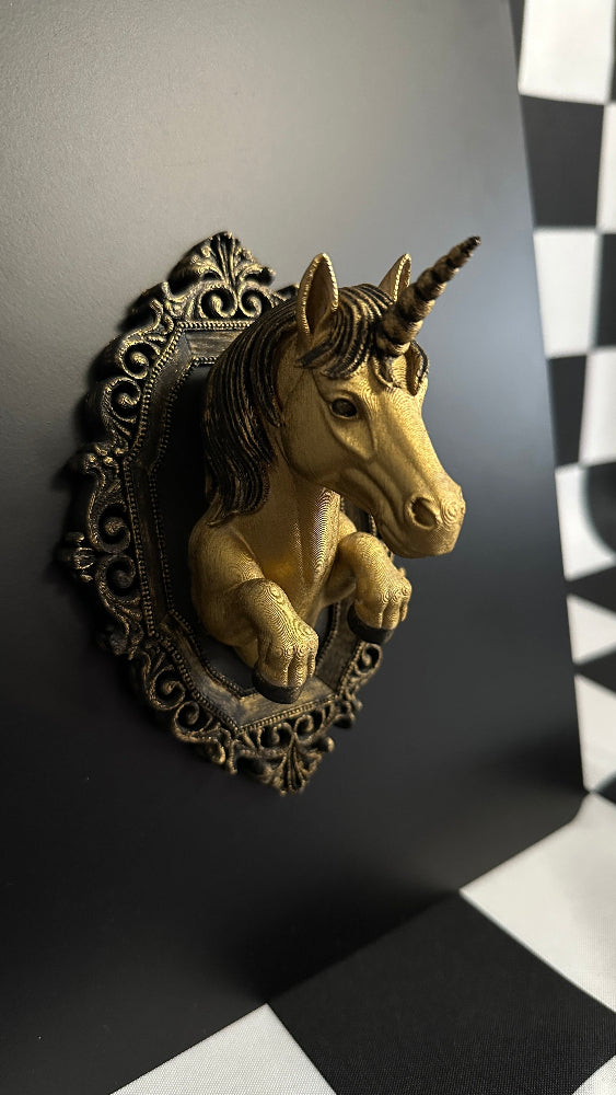 Decorative unicorn head mounted on a wall with a checkered floor in the background