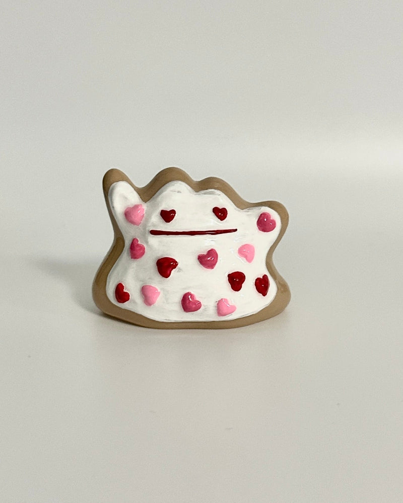 Small decorative item with heart patterns on a white surface