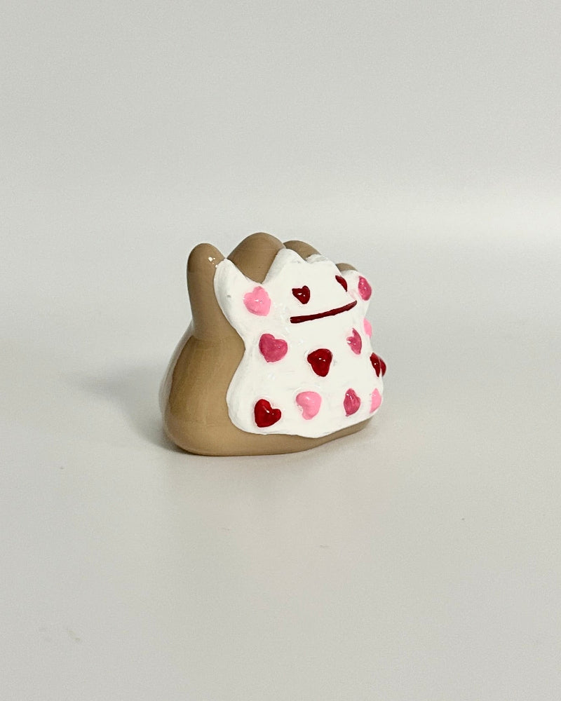 Small decorative item with heart patterns on a white surface