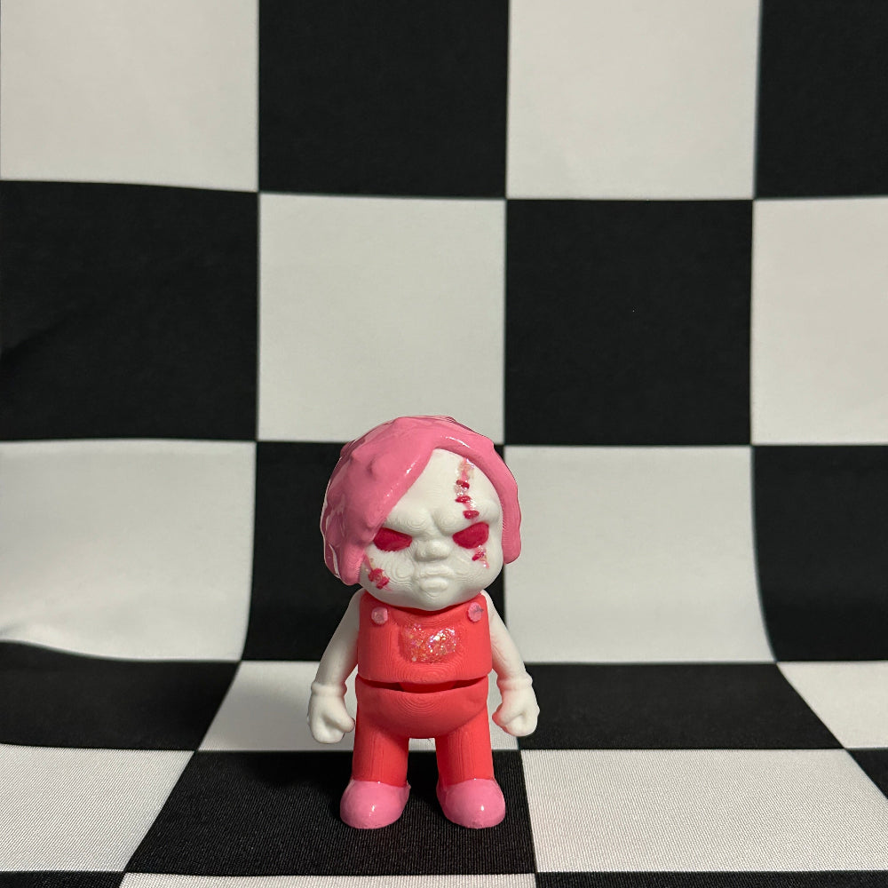 Toy figure with pink hair and outfit on a checkered background