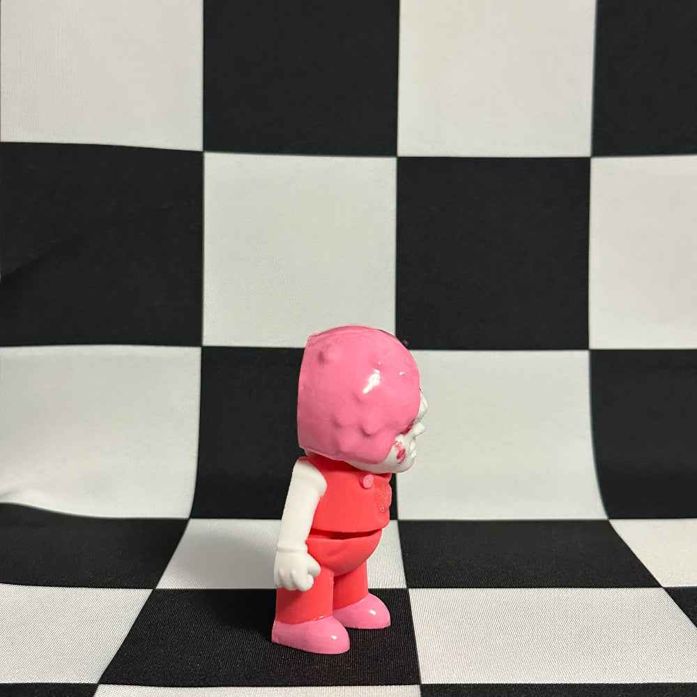Pink and red character figure on a black and white checkered background