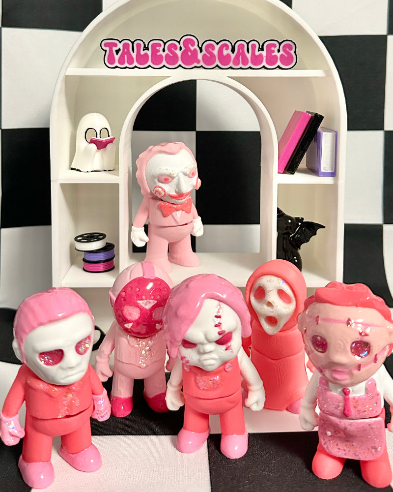Toy figures with pink and white outfits on a checkered background