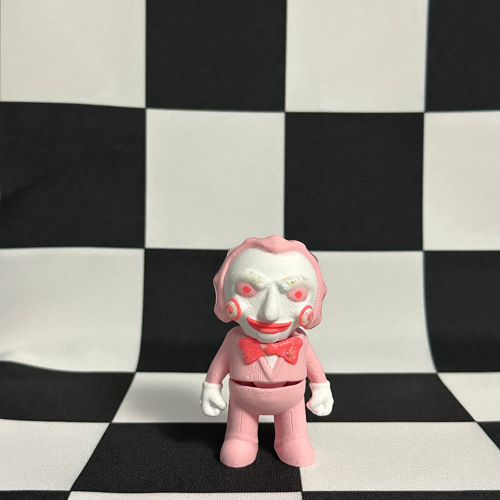 Pink clown figurine with a checkered black and white background