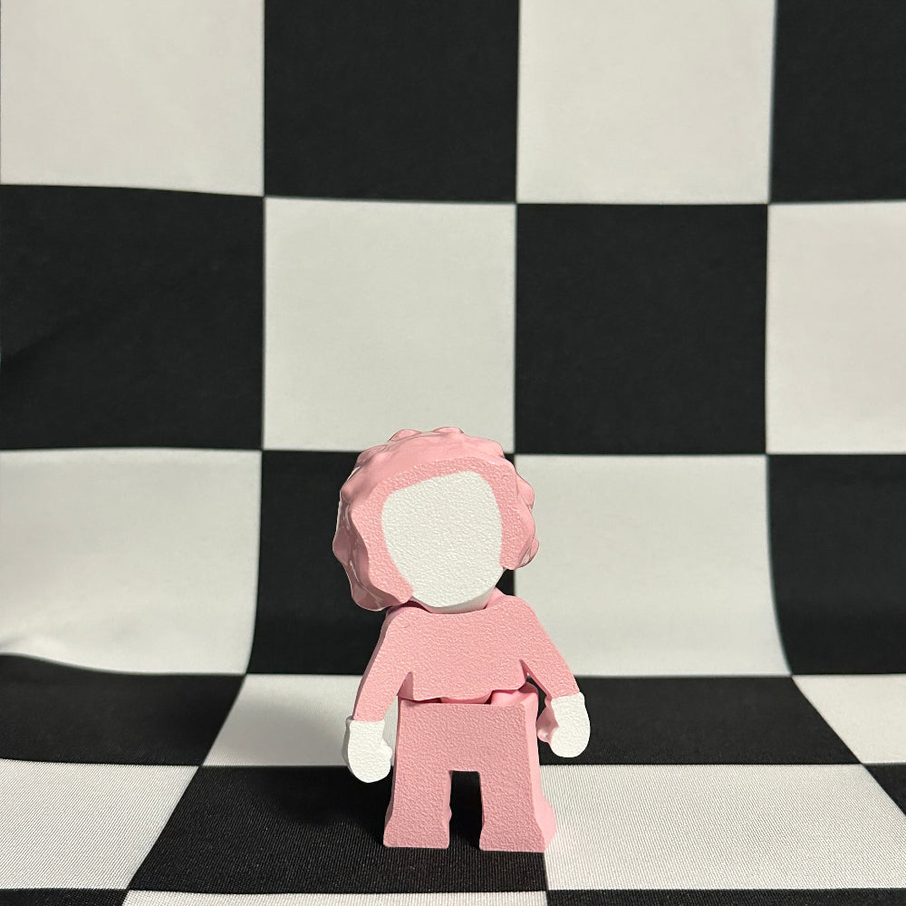 Small figure wearing a pink outfit on a black and white checkered background