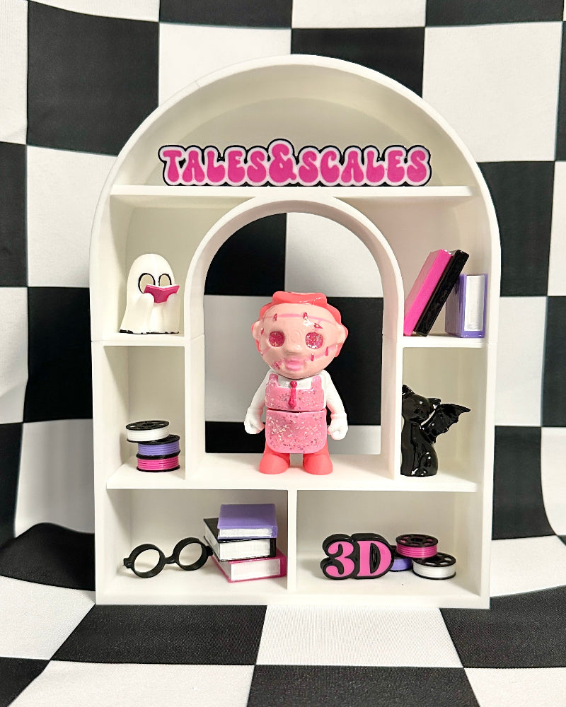 Small white shelf with various items against a black and white checkered background