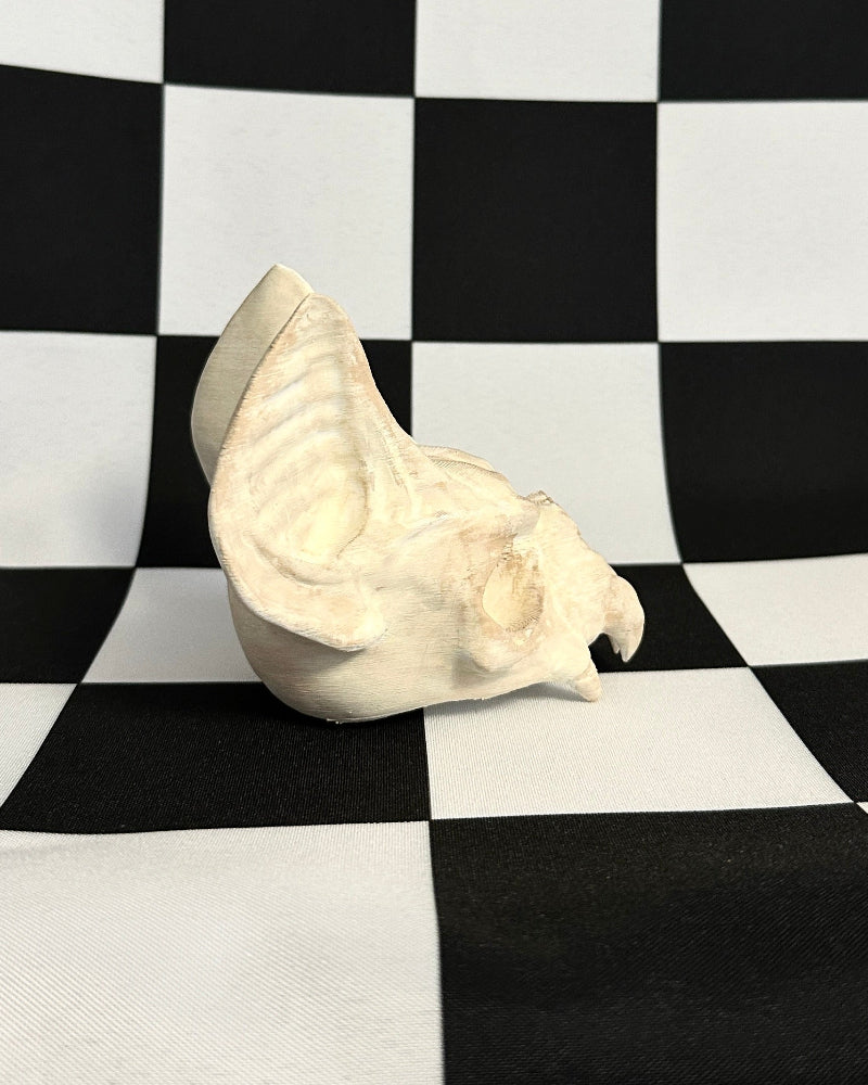 White bat skull on a black and white checkered background