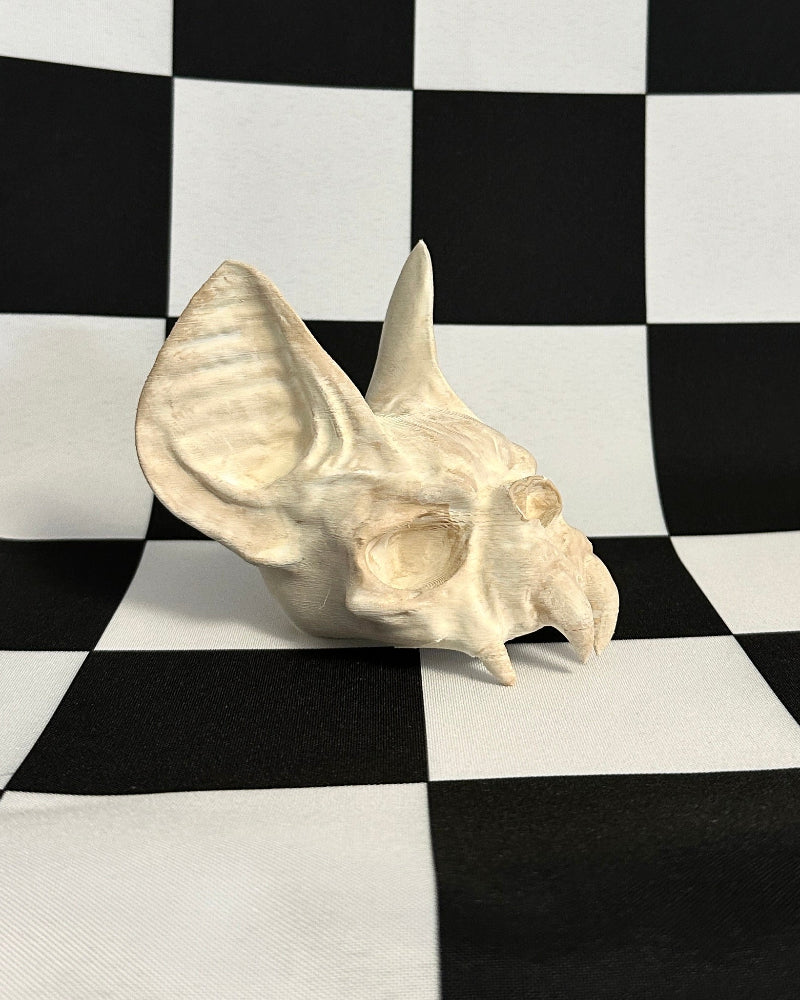 bat skull model on a black and white checkered background