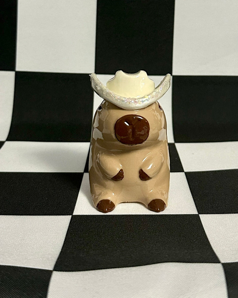 Small figurine with a checkered black and white background