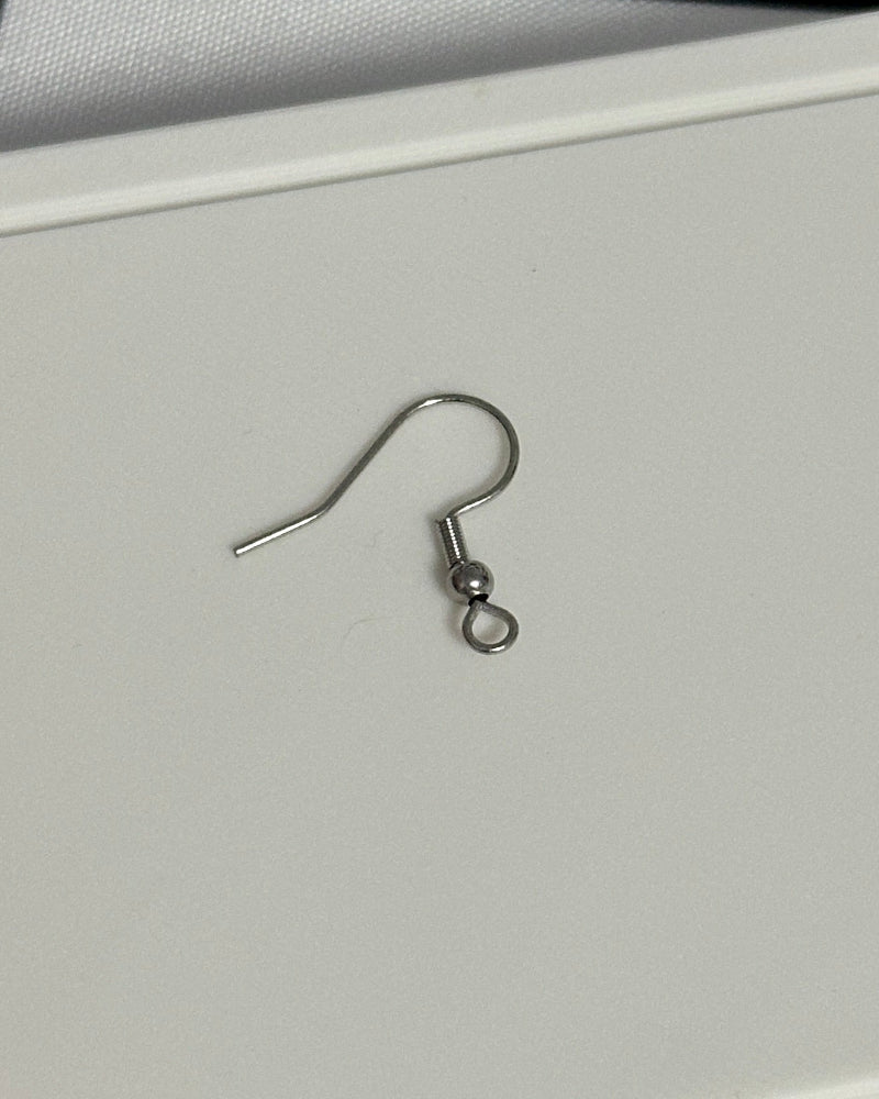 Earring on a white card with a checkered background