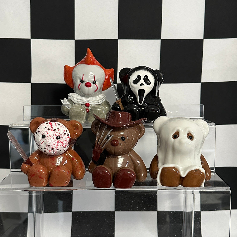 Decorative figurines on a clear stand against a black and white checkered background
