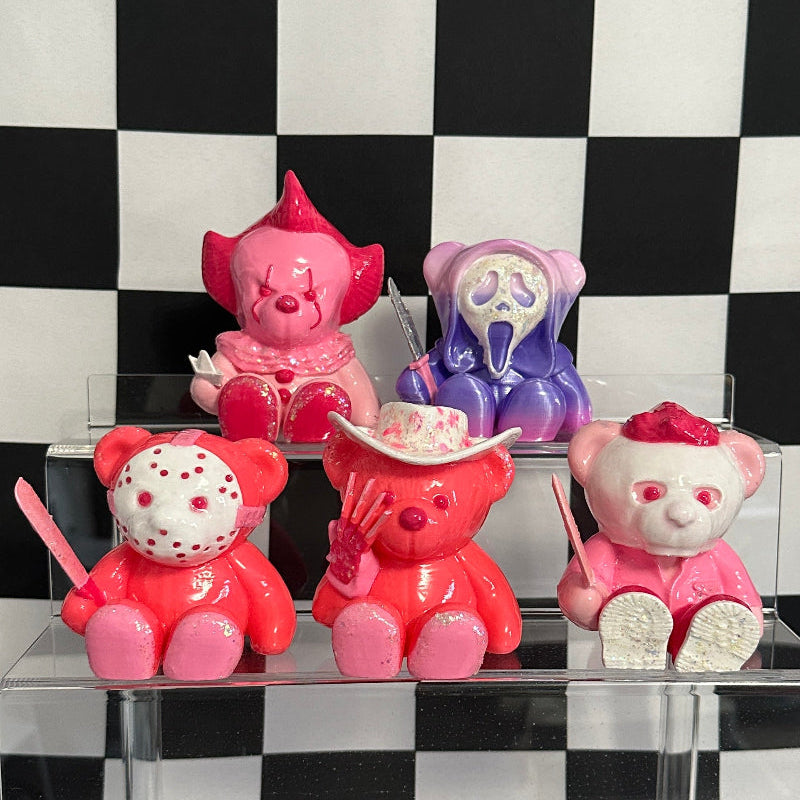 Colorful teddy bears with unique designs on a black and white checkered background